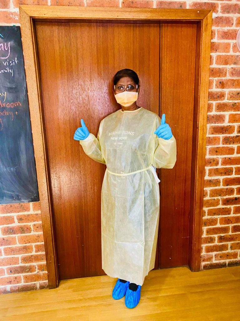 Thumbs up staff wearing PPE