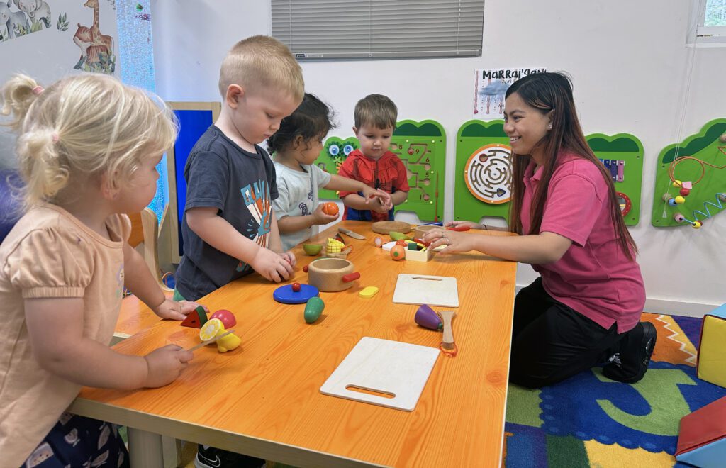 Children playing with educator