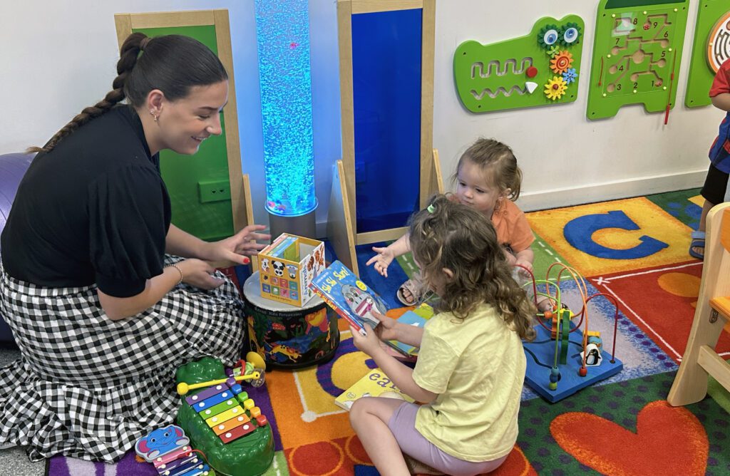 Educator smiling at children