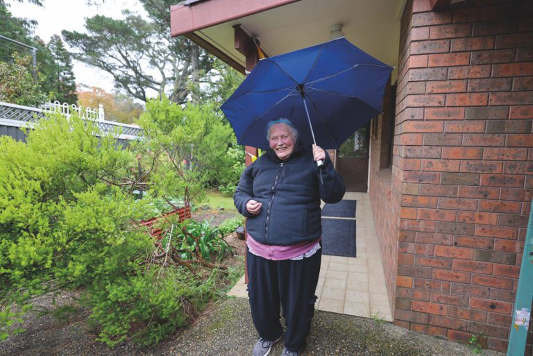 Resident smiling outside of home