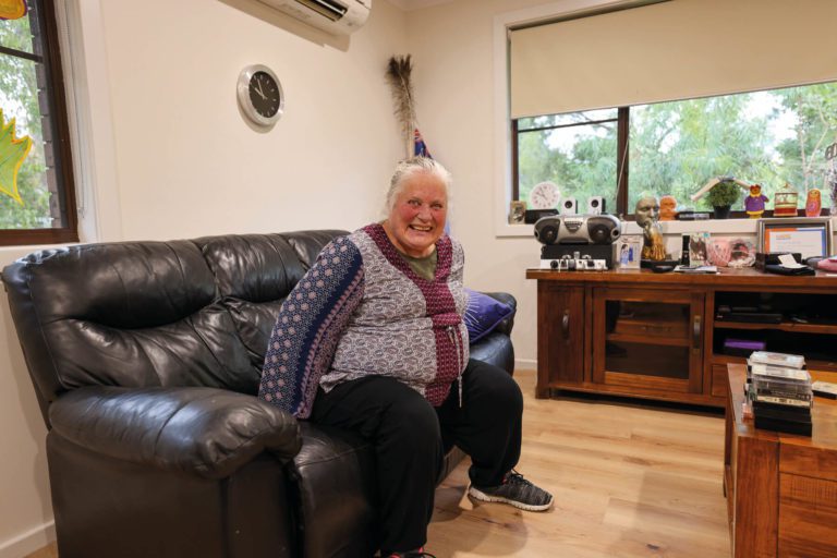 Resident smiling on couch